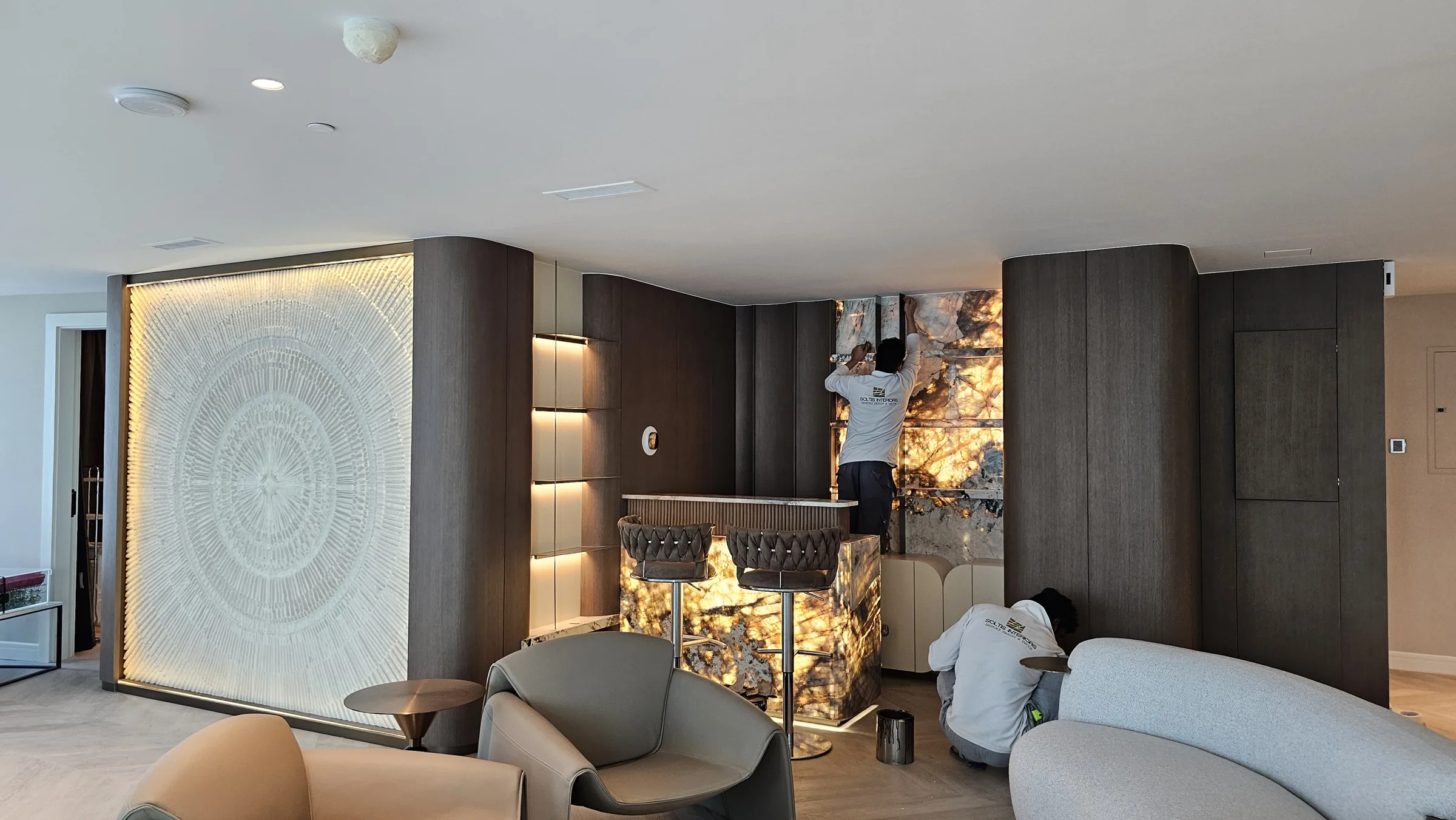 Soltis Interiors team installing backlit onyx and joinery on a luxury interior fit-out in Dubai